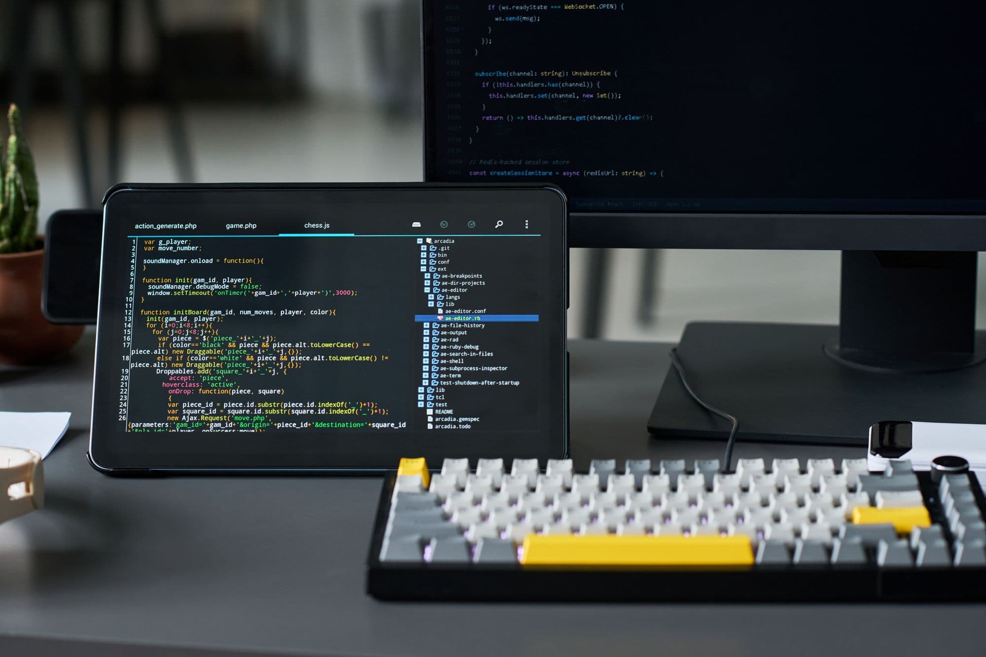 A developer workspace displaying code on a tablet for software development